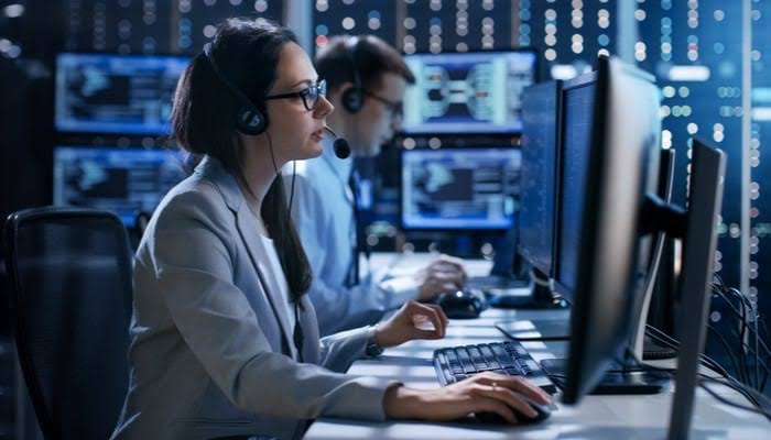 Security analysts monitoring multiple screens